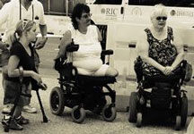 Old photo of 3 people with disabilities at an ADA protest.